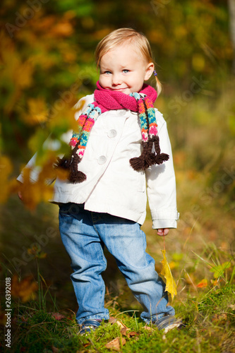Toddler girl in autumn forest