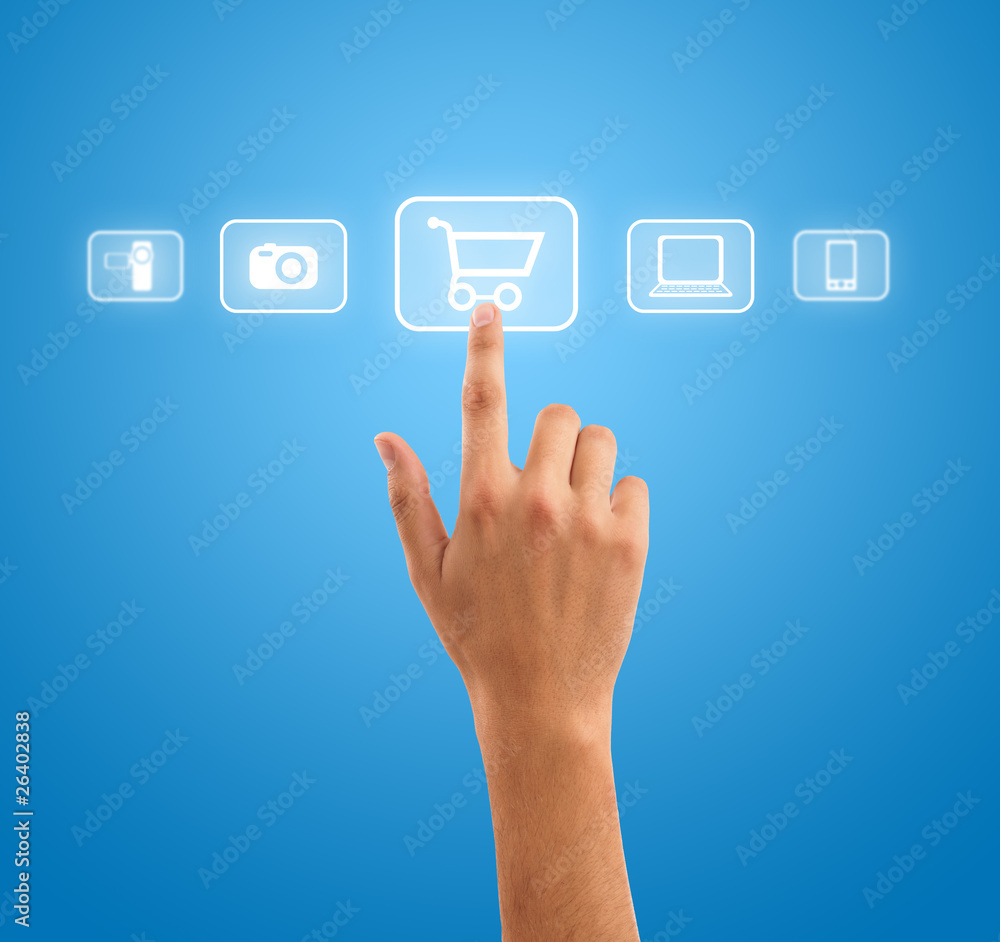 Hand pressing shopping cart symbol from media icons on blue back Hand pressing shopping cart symbol from media icons on blue back