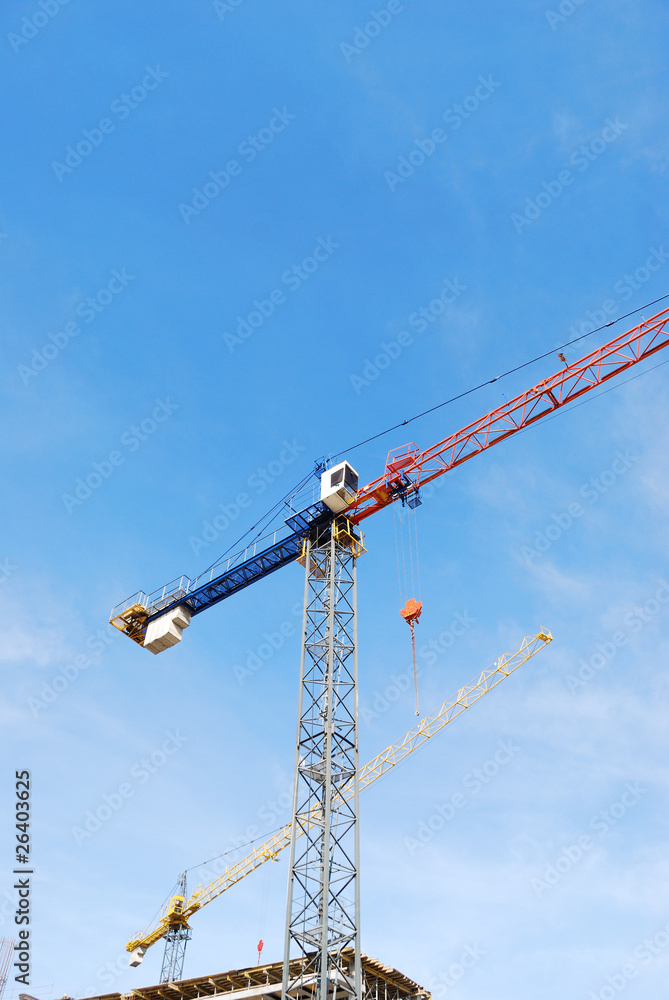 The tower crane against the blue sky The tower crane against the blue sky