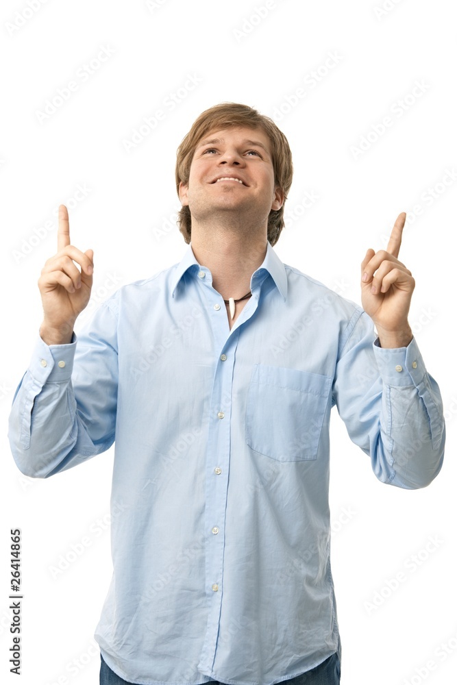 Casual young man pointing up Casual young man pointing up