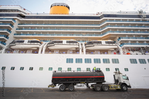 gas-tank truck staying in Qaboos Port. Cruise ship behind truck