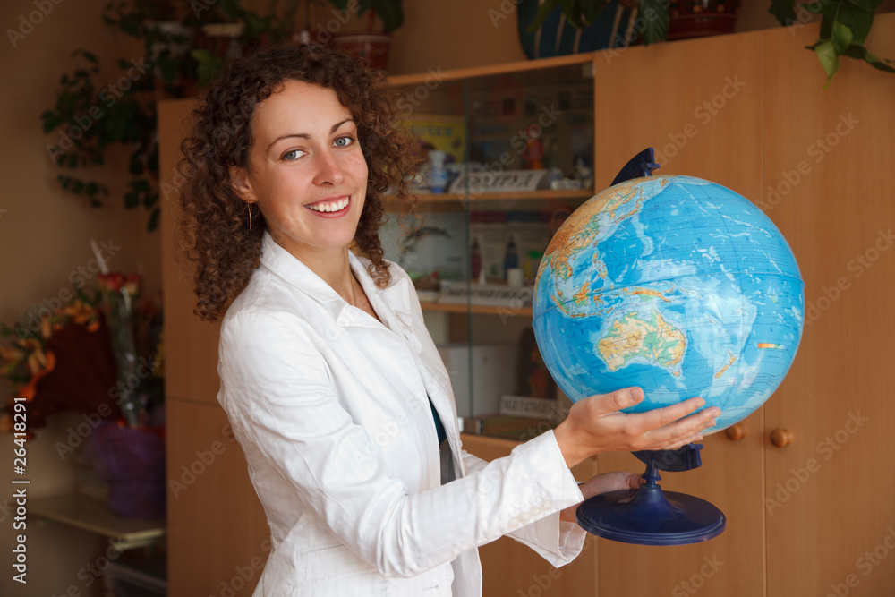 Portrait of schoolteacher in school. Smiling, holding globe Portrait of schoolteacher in school. Smiling, holding globe