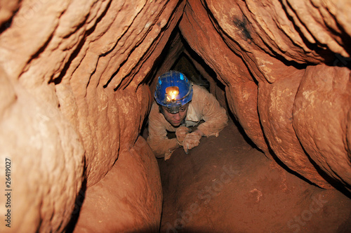 Caver in a narrow passage