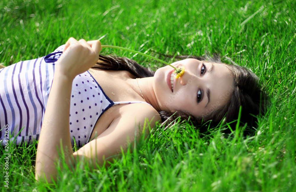 a charming young woman lying on a summer meadow a charming young woman lying on a summer meadow