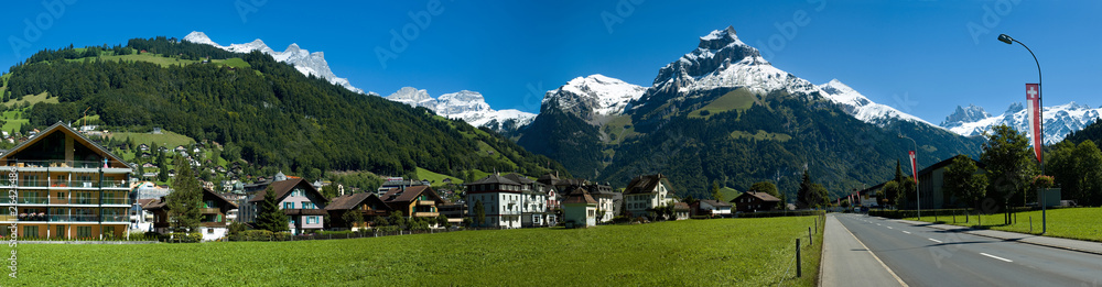 Swiss village, road and alpine mountains