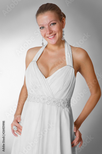 Beautiful woman wearing luxurious wedding dress studio