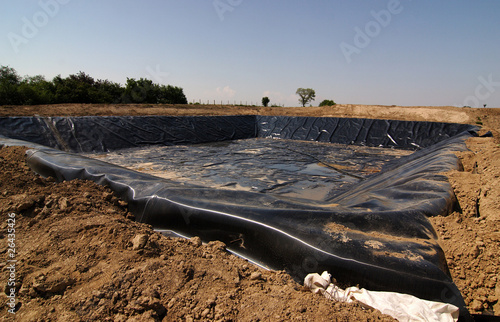 Empty new landfill with plastic isolating layer photo