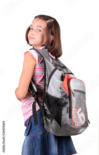 Young schoolgirl with schoolbag look back