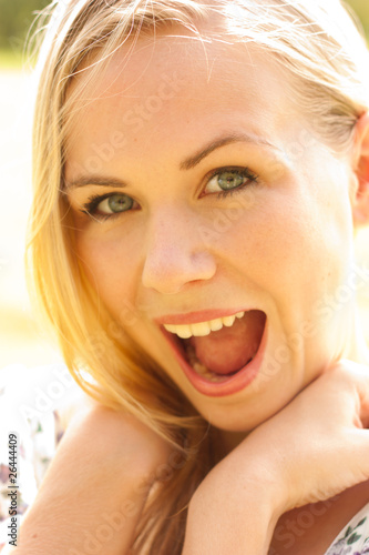 Expressive closeup portrait of young surprised woman
