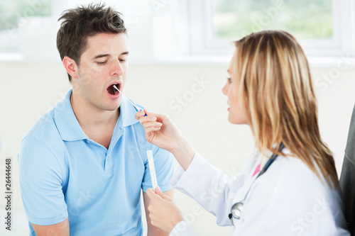 Female doctor extracting saliva