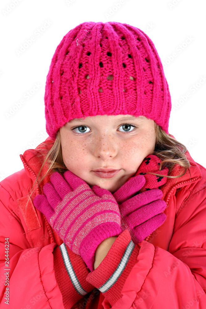 Small girl in winter clothes embracing herself isolated on white Small girl in winter clothes embracing herself isolated on white