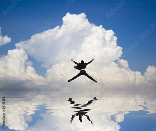 businessman jumping on the water and Reflection