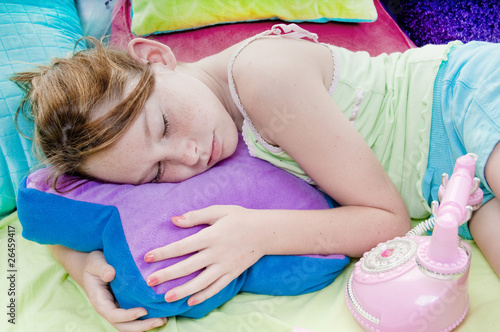 Картината върху платно Young girl asleep by phone