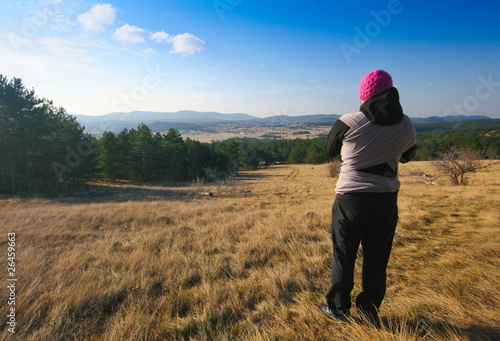 Young mother admiring the view on autumn walk with newborn © Uroš Medved