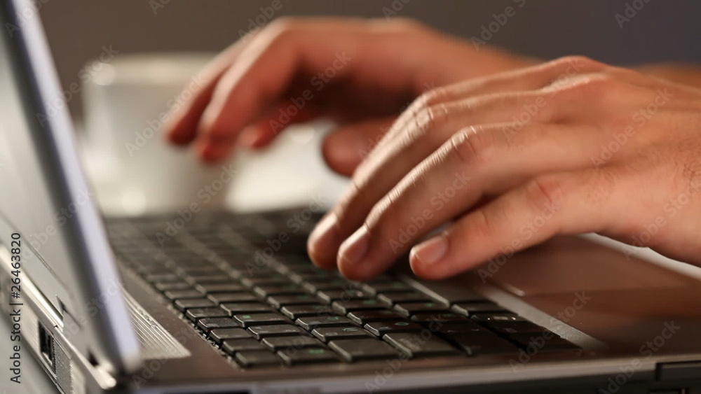 Hands typing on laptop keyboard and credit card Hands typing on laptop keyboard and credit card