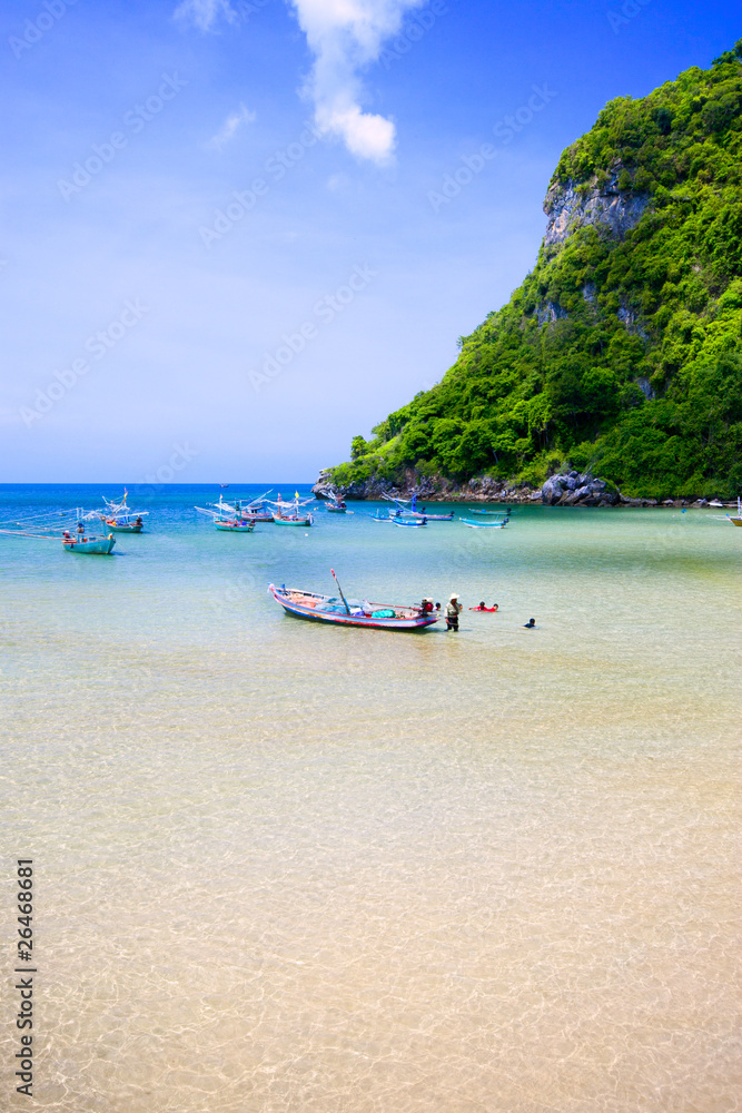 Old boats on the white sand