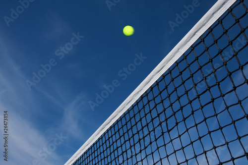 Tennis ball flying over the net © Marquis Washington