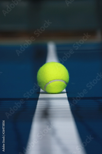 Tennis ball on the boundary in the middle ground © Marquis Washington