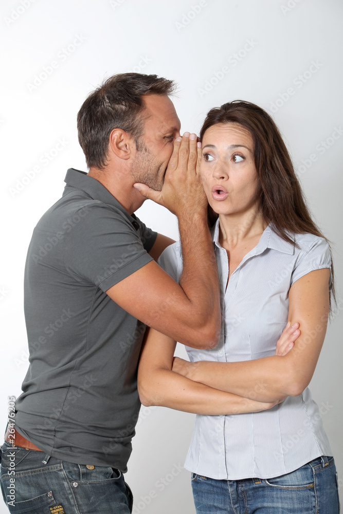 Man whispering to his girlfriend ear Man whispering to his girlfriend ear