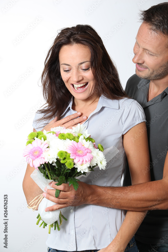 Man giving bunch of flowers to girlfriends