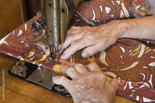 hands of grandmother by needlework photo