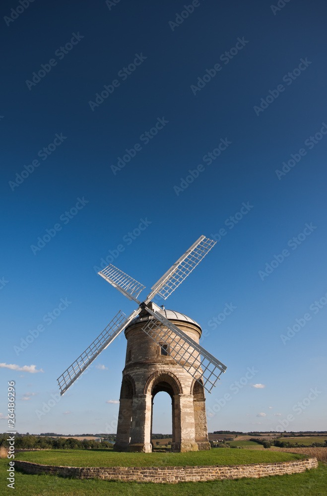Traditional stone windmill under blue skies