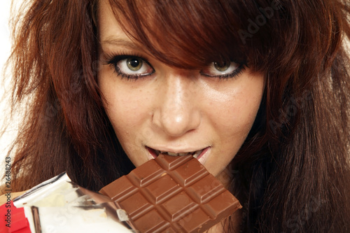 The girl bites chocolate