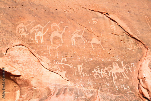 Images of camels carved into a rock wall at Wadi Rum