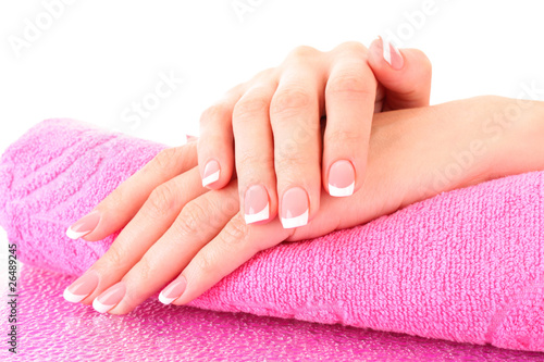Beautiful woman hands with french manicure on pink background