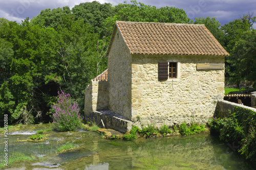 The house is surrounded by water