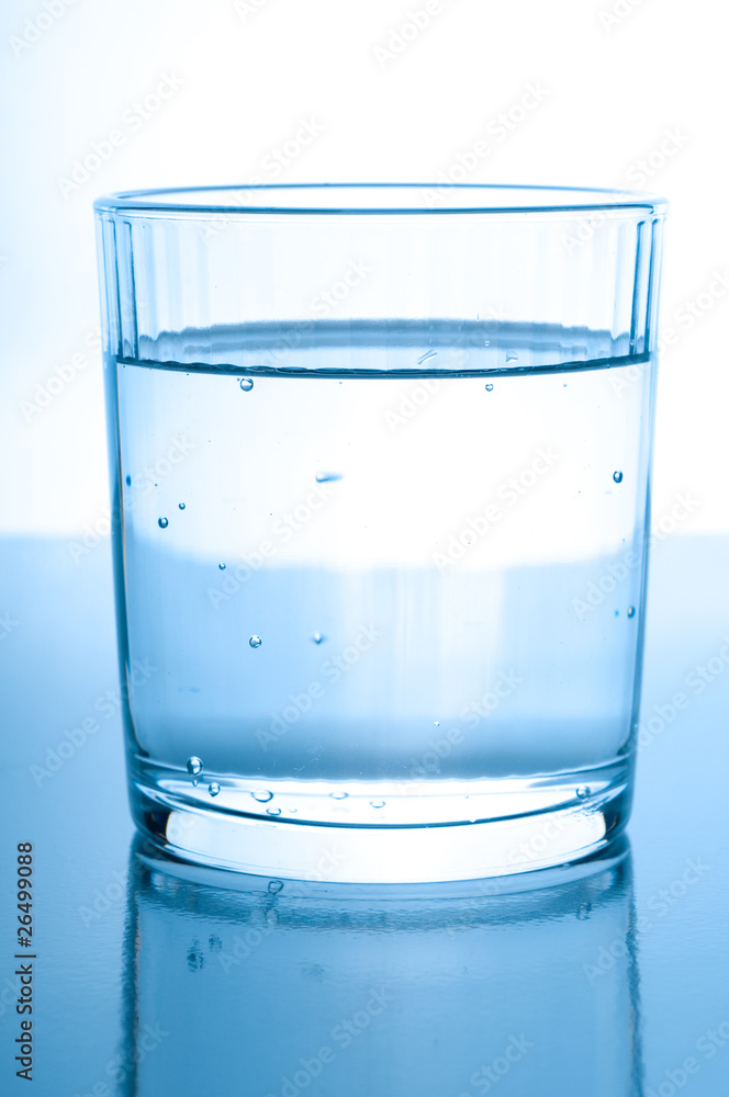 glass with water on glossy background glass with water on glossy background