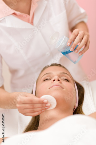 Skin care - woman cleaning face