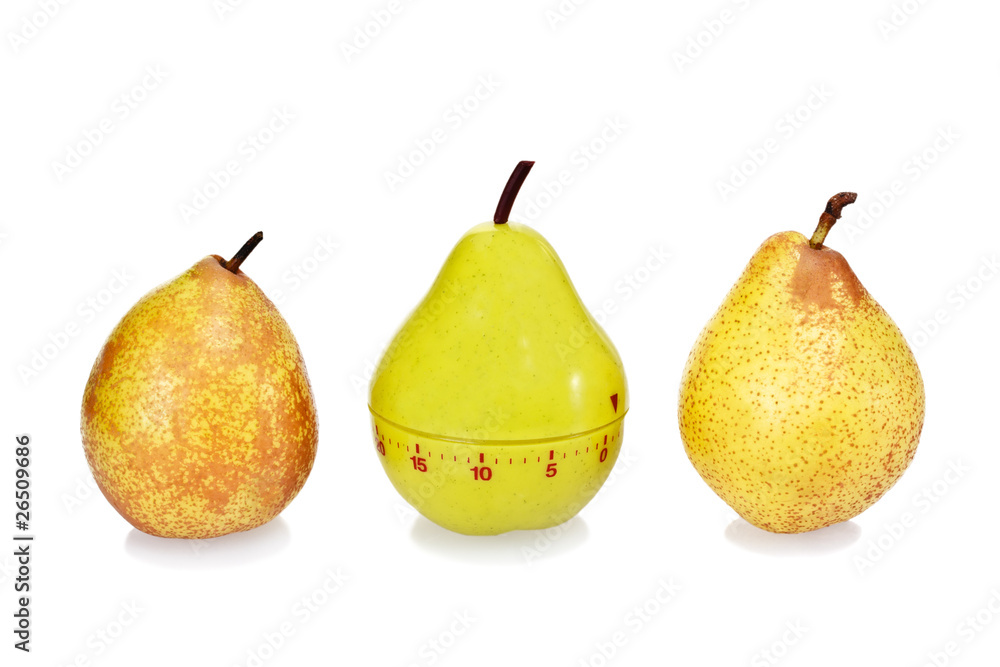 Two ripe fresh pears and green plastic pear timer Two ripe fresh pears and green plastic pear timer