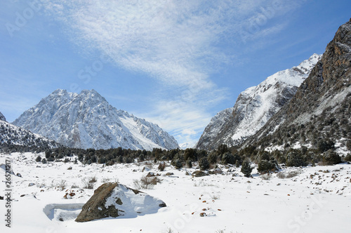 Winter in mountains with blue sky and clouds