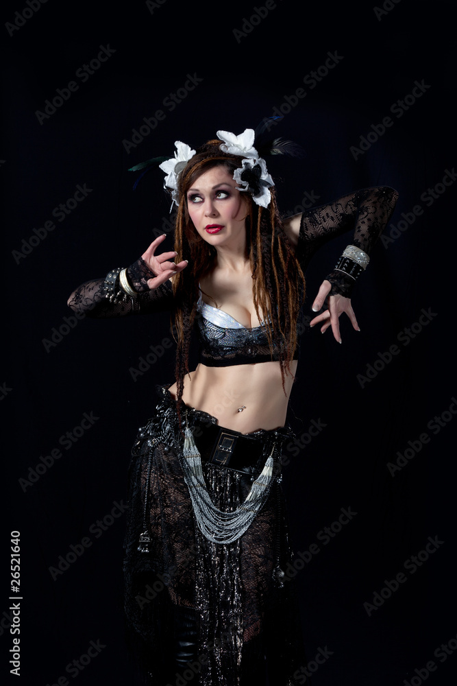 Attractive bellydancer  dancing in tribal makeup and dress