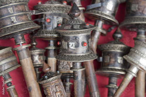 Silver Tibetan prayer wheels on stall at Swayambhu, Nepal