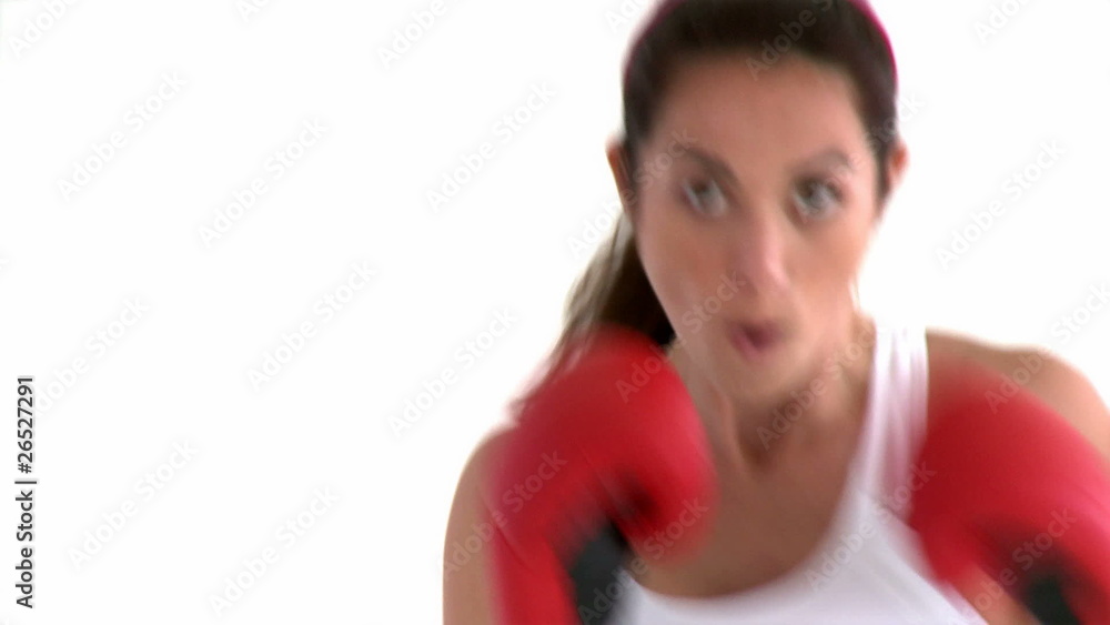 Portrait of an athletic woman boxing against white background Portrait of an athletic woman boxing against white background