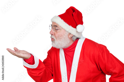 Santa Claus magically blowing in the palm of his hand