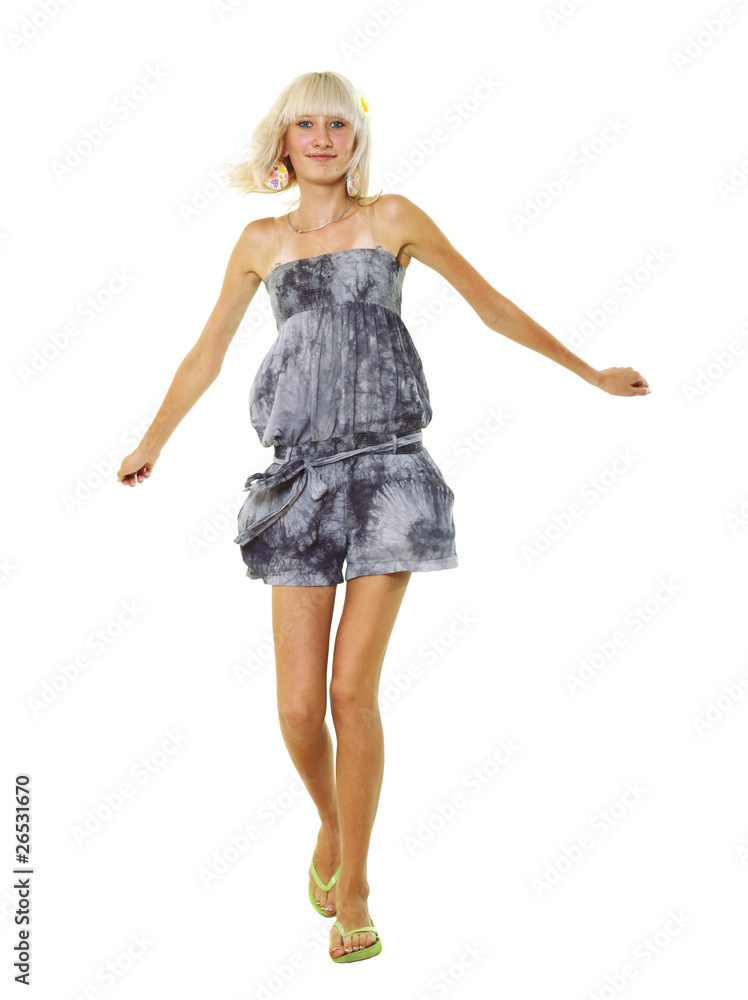 Fototapeta premium The young blonde goes on a white background