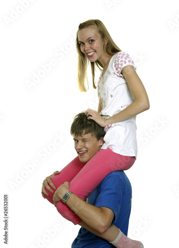 The girl sits astride the young man