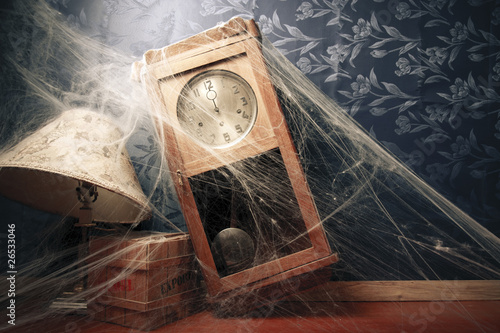 vintage wall clock full of cobwebs