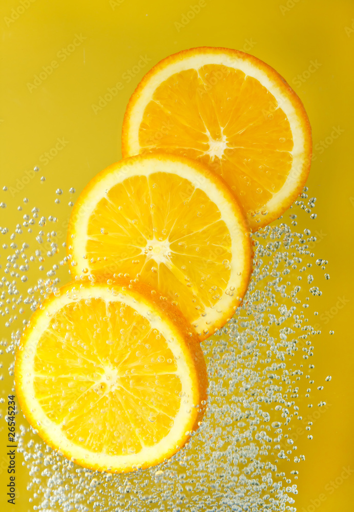 Fresh orange dropped into water Fresh orange dropped into water