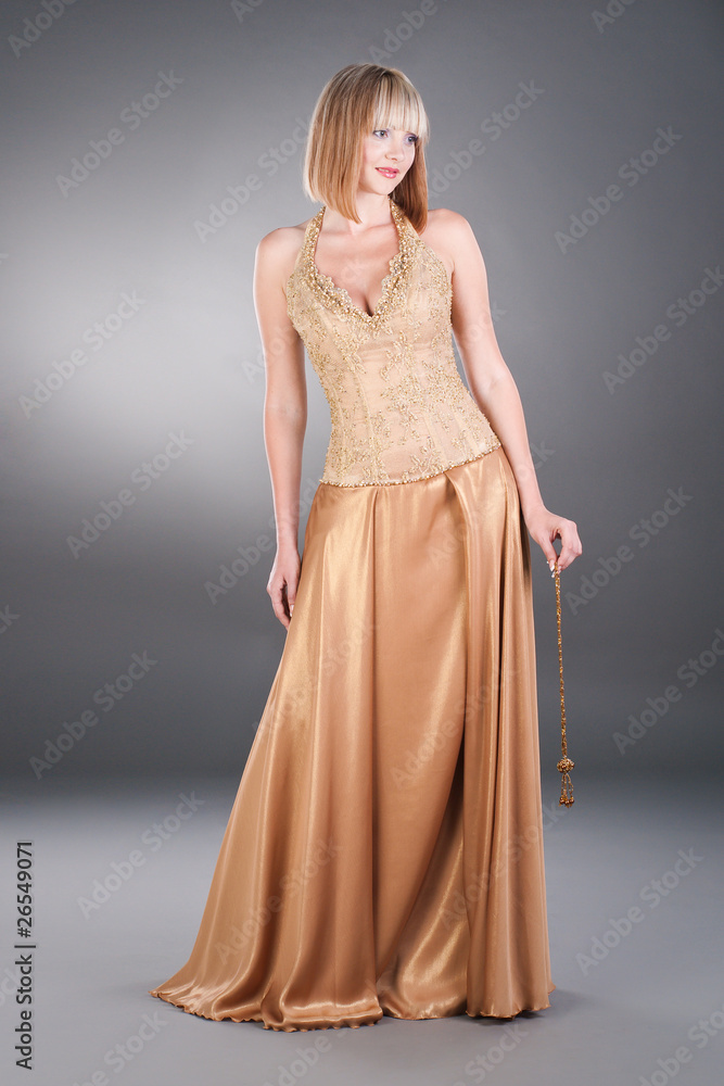 pretty white woman wearing gold evening dress