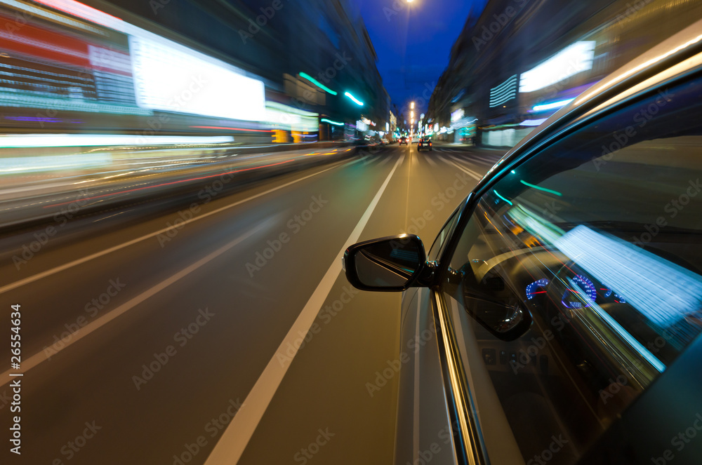 Car driving fast in the night city