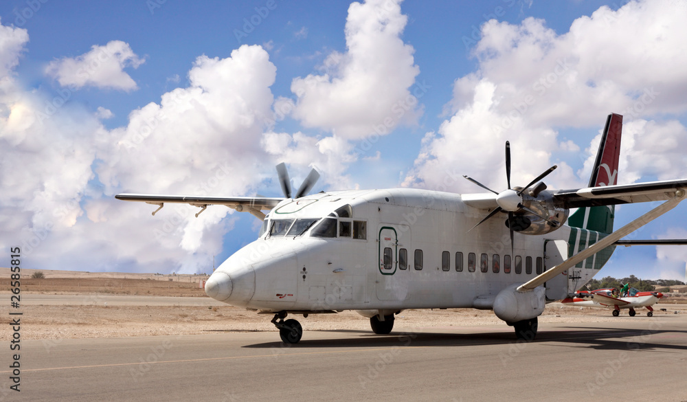 Airplane with propellers landing on a desert airport Airplane with propellers landing on a desert airport