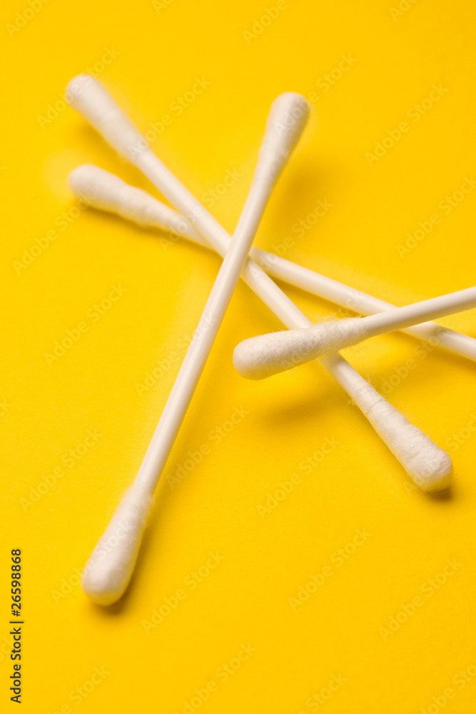 Cotton swabs isolated on yellow background Cotton swabs isolated on yellow background