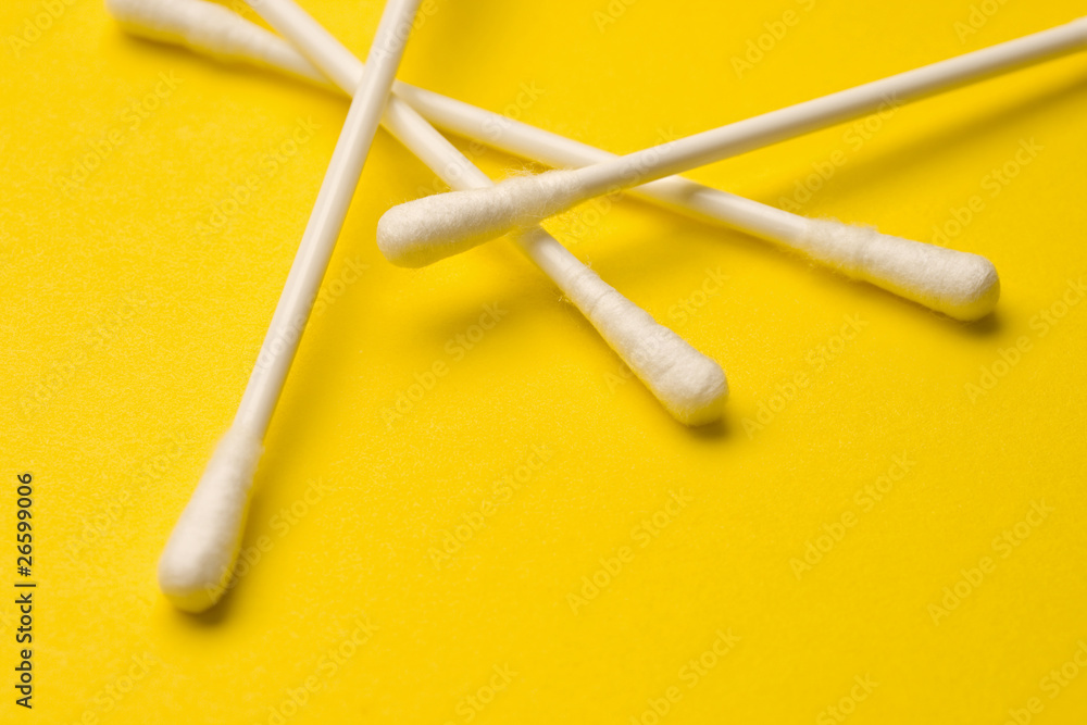 Cotton swabs isolated on yellow background Cotton swabs isolated on yellow background