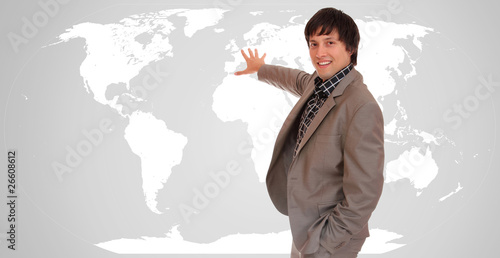 Young attractive businessman with world map