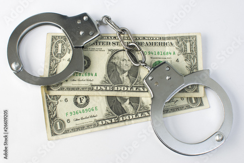 Close-up handcuffs and money