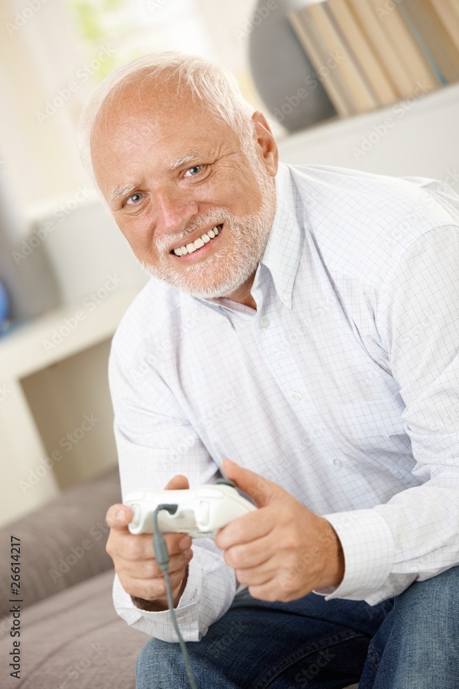 Portrait of modern senior playing computer game Portrait of modern senior playing computer game